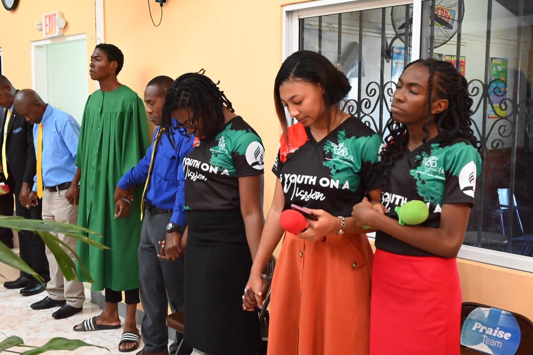 Young adults praying together as Youth on a Mission
